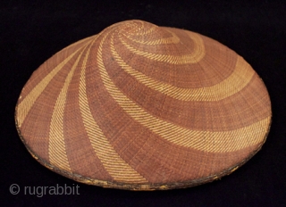 Salakot hat, Philippines. Woven rattan. 16" high by 13" wide, as shown in first photo. 19th-20th century. There are some small spots of loss along the edge and on the underside as  ...