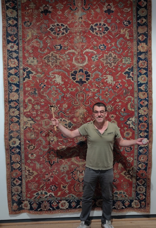 Milani hangs an early Northwest Persian kelleh carpet